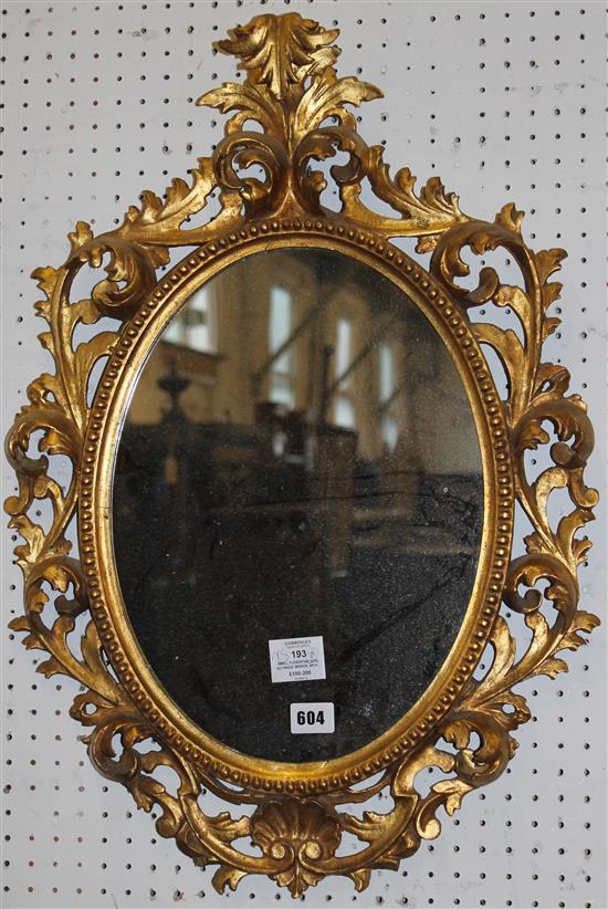 Small Florentine oval giltwood mirror, with carved acanthu surround